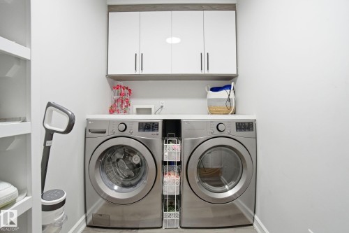 Laundry area with cabinet space and washer and clothes dryer - 1532 37C Avenue, Edmonton, AB - Indoor Photo Showing Laundry Room