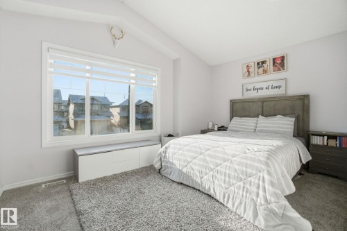 Carpeted bedroom with lofted ceiling and baseboards - 1532 37C Avenue, Edmonton, AB - Indoor Photo Showing Bedroom
