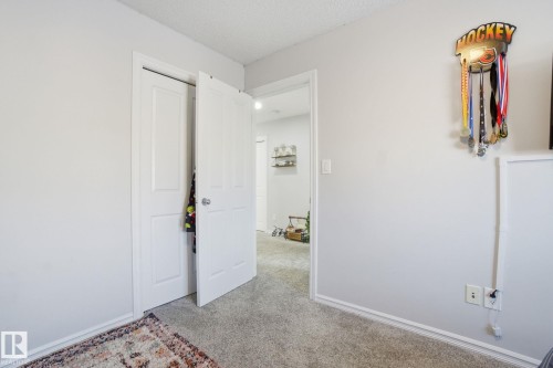 Unfurnished bedroom featuring light colored carpet and a textured ceiling - 1532 37C Avenue, Edmonton, AB - Indoor Photo Showing Other Room