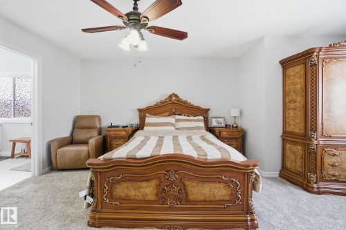 Bedroom with light colored carpet, ceiling fan, and connected bathroom - 1532 37C Avenue, Edmonton, AB - Indoor Photo Showing Bedroom