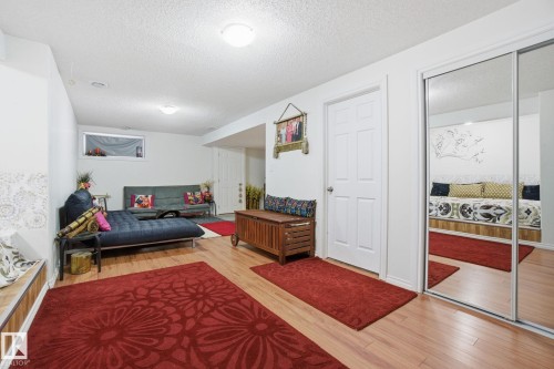 Living area featuring light wood-style flooring and a textured ceiling - 1532 37C Avenue, Edmonton, AB - Indoor