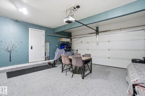 Garage with a garage door opener and baseboards - 1532 37C Avenue, Edmonton, AB - Indoor Photo Showing Garage