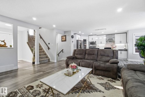 Living room with wood finished floors, stairway, and recessed lighting - 1532 37C Avenue, Edmonton, AB - Indoor Photo Showing Living Room