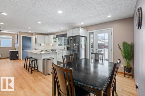 Dining area featuring light wood-style floors, recessed lighting, and a textured ceiling - 1 Larkspur Crescent, St. Albert, AB - Indoor Photo Showing Dining Room