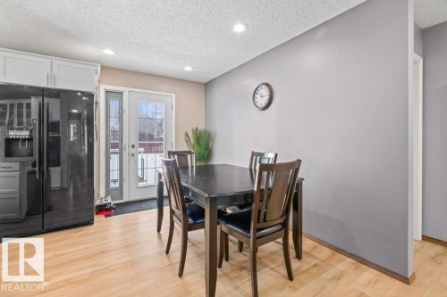 Dining area featuring a textured ceiling, light wood-type flooring, and recessed lighting - 1 Larkspur Crescent, St. Albert, AB - Indoor Photo Showing Dining Room
