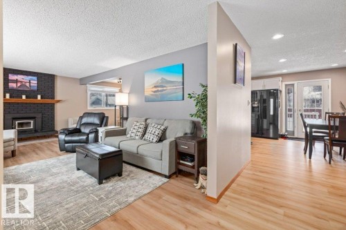 Living room with light wood finished floors, a textured ceiling, and recessed lighting - 1 Larkspur Crescent, St. Albert, AB - Indoor Photo Showing Living Room With Fireplace