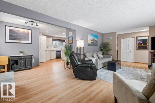 Living room featuring light wood-style flooring, a textured ceiling, and recessed lighting - 1 Larkspur Crescent, St. Albert, AB - Indoor Photo Showing Living Room