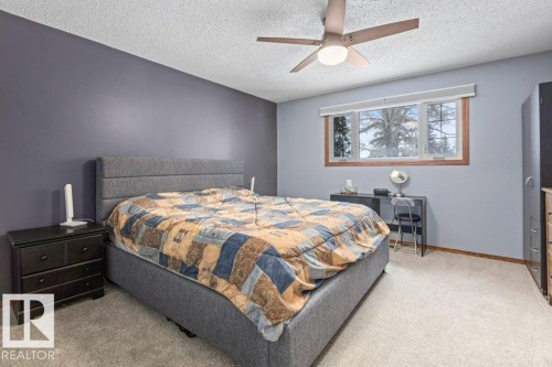 Bedroom with light colored carpet, ceiling fan, and a textured ceiling - 1 Larkspur Crescent, St. Albert, AB - Indoor Photo Showing Bedroom