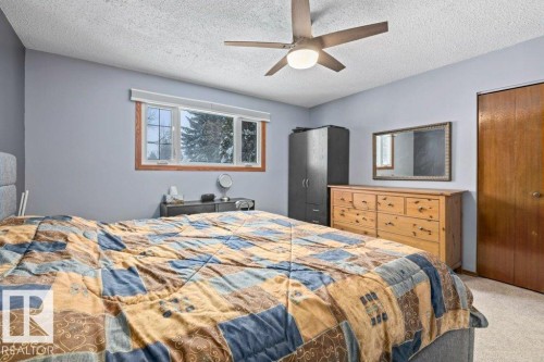 Bedroom featuring carpet, a closet, a ceiling fan, and a textured ceiling - 1 Larkspur Crescent, St. Albert, AB - Indoor Photo Showing Bedroom