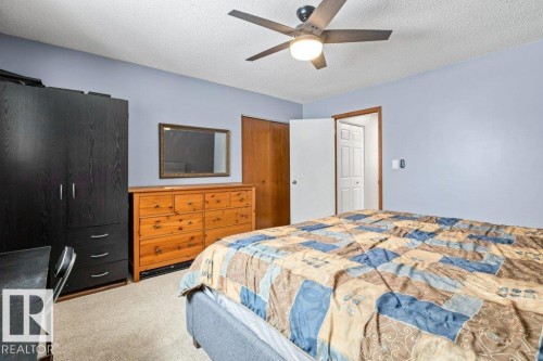 Bedroom with a closet, a textured ceiling, light colored carpet, and a ceiling fan - 1 Larkspur Crescent, St. Albert, AB - Indoor Photo Showing Bedroom
