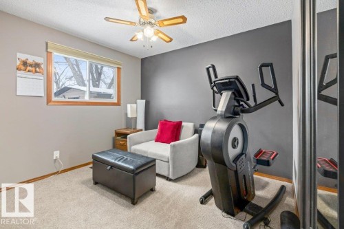 Exercise room featuring carpet, a textured ceiling, and ceiling fan - 1 Larkspur Crescent, St. Albert, AB - Indoor
