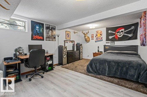 Bedroom with a desk, a textured ceiling, and light wood-type flooring - 1 Larkspur Crescent, St. Albert, AB - Indoor Photo Showing Bedroom