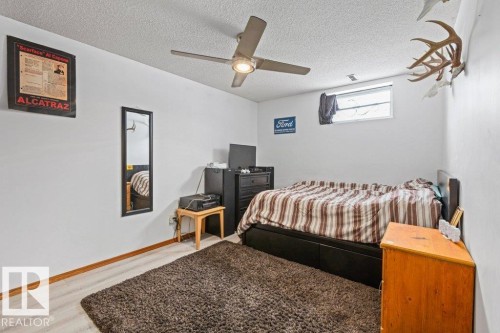 Bedroom featuring a textured ceiling, wood finished floors, and a ceiling fan - 1 Larkspur Crescent, St. Albert, AB - Indoor Photo Showing Bedroom