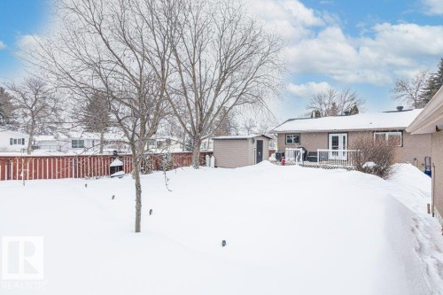Yard covered in snow featuring a shed and a wooden deck - 1 Larkspur Crescent, St. Albert, AB - Outdoor
