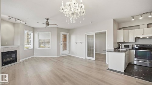 Edmonton, AB - Indoor Photo Showing Kitchen With Fireplace