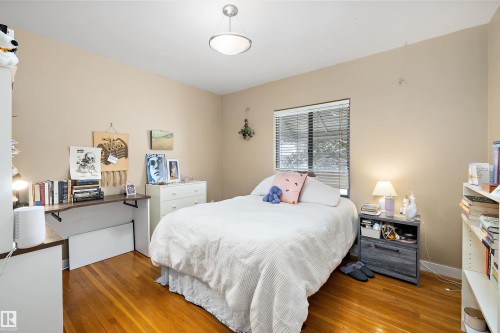 Bedroom featuring wood-type flooring - 11242 72 Avenue, Edmonton, AB - Indoor Photo Showing Bedroom