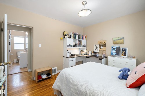 Bedroom featuring wood finished floors and baseboards - 11242 72 Avenue, Edmonton, AB - Indoor Photo Showing Bedroom