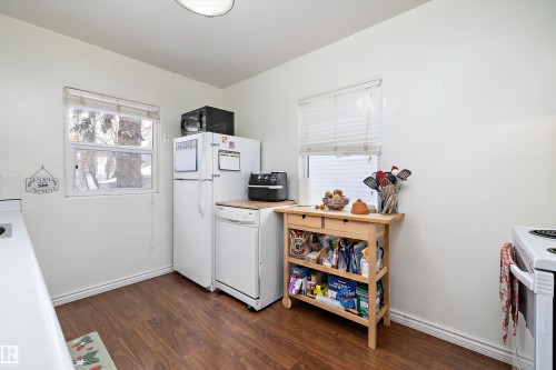 Kitchen with dark wood-type flooring, light countertops, white appliances, and white cabinets - 11242 72 Avenue, Edmonton, AB - Indoor Photo Showing Kitchen