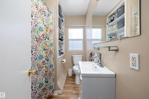 Bathroom with vanity, a shower with shower curtain, and light wood-style flooring - 11242 72 Avenue, Edmonton, AB - Indoor Photo Showing Bathroom