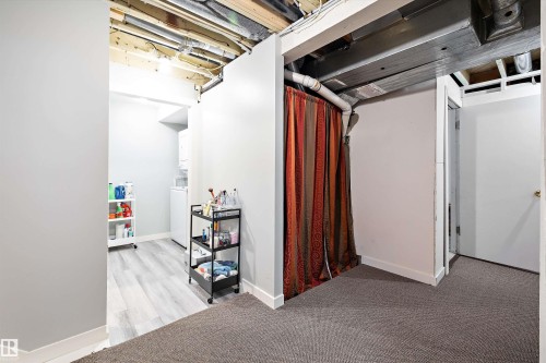 Basement featuring baseboards and light carpet - 11242 72 Avenue, Edmonton, AB - Indoor
