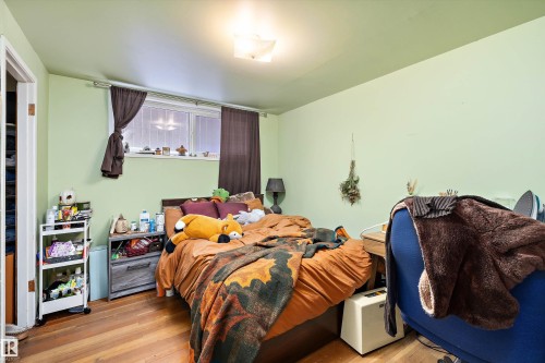 Bedroom with hardwood / wood-style flooring - 11242 72 Avenue, Edmonton, AB - Indoor Photo Showing Bedroom
