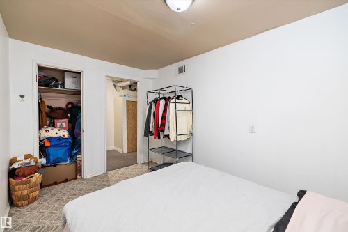 Bedroom featuring a closet and light carpet - 11242 72 Avenue, Edmonton, AB - Indoor Photo Showing Bedroom