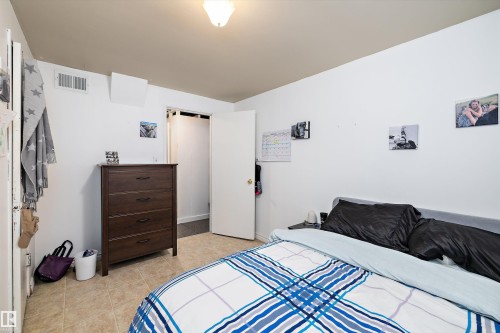 Bedroom with light tile patterned floors - 11242 72 Avenue, Edmonton, AB - Indoor Photo Showing Bedroom