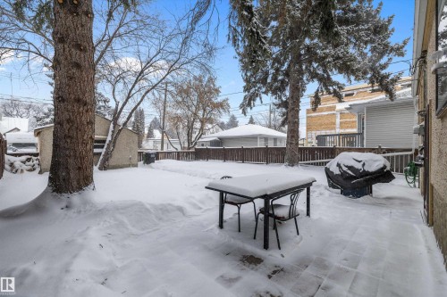 Snow covered patio with grilling area and a residential view - 11242 72 Avenue, Edmonton, AB - Outdoor