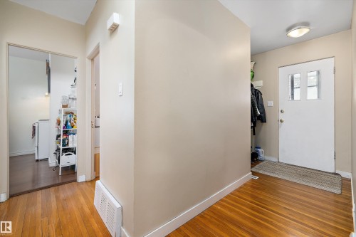 Foyer entrance with light wood-type flooring and baseboards - 11242 72 Avenue, Edmonton, AB - Indoor Photo Showing Other Room