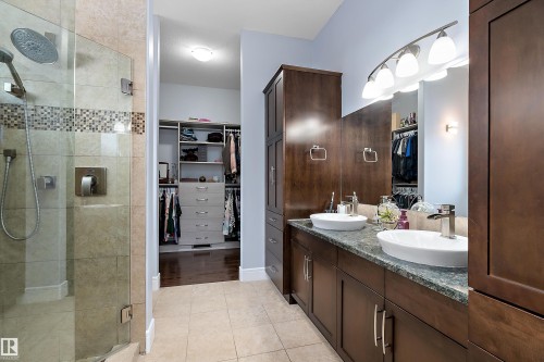 Full bathroom with a walk in closet, double vanity, a shower stall, and light tile patterned flooring - 1409 Westerra Bay, Stony Plain, AB - Indoor Photo Showing Bathroom