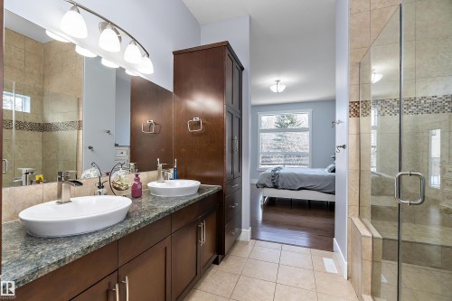Ensuite bathroom with a stall shower, double vanity, and light tile patterned floors - 1409 Westerra Bay, Stony Plain, AB - Indoor Photo Showing Bathroom