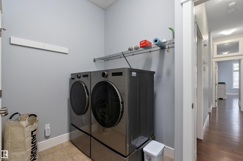 Laundry area featuring washer and clothes dryer and baseboards - 1409 Westerra Bay, Stony Plain, AB - Indoor Photo Showing Laundry Room