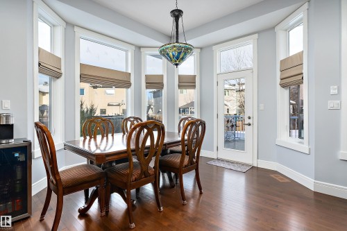 Dining room featuring wine cooler, plenty of natural light, and dark wood-type flooring - 1409 Westerra Bay, Stony Plain, AB - Indoor Photo Showing Dining Room