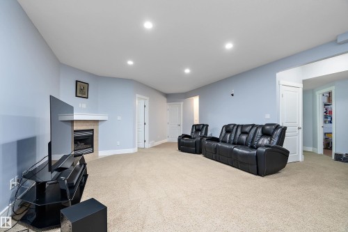 Living room with a fireplace, recessed lighting, and light colored carpet - 1409 Westerra Bay, Stony Plain, AB - Indoor With Fireplace
