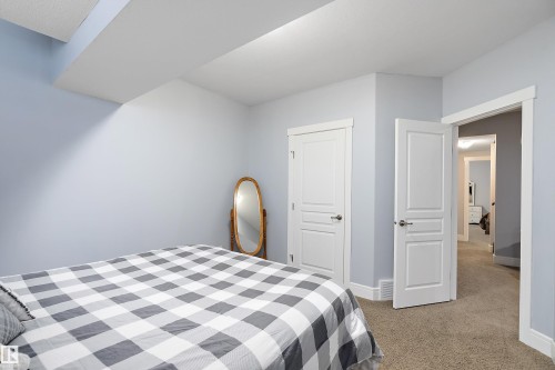Bedroom with light carpet and baseboards - 1409 Westerra Bay, Stony Plain, AB - Indoor Photo Showing Bedroom