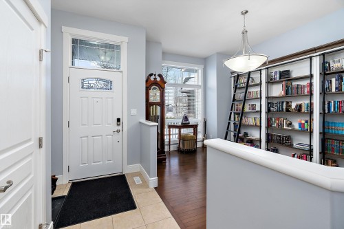 Entryway featuring light tile patterned floors and baseboards - 1409 Westerra Bay, Stony Plain, AB - Indoor Photo Showing Other Room