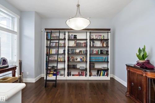 Sitting room with baseboards and dark wood finished floors - 1409 Westerra Bay, Stony Plain, AB - Indoor Photo Showing Other Room
