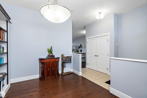 Foyer featuring wood finished floors and baseboards - 1409 Westerra Bay, Stony Plain, AB - Indoor Photo Showing Other Room