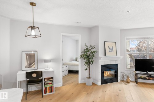 207 12028 103 Avenue, Edmonton, AB - Indoor Photo Showing Living Room With Fireplace