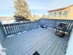 Wooden terrace featuring a grill - 