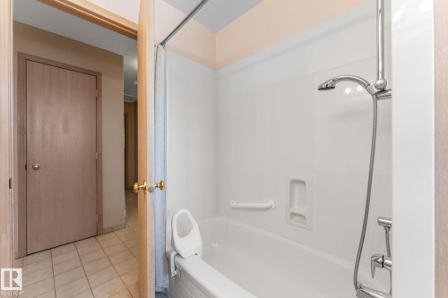 Bathroom with shower / tub combo with curtain and tile patterned floors - 3519 111B Street, Edmonton, AB - Indoor Photo Showing Bathroom