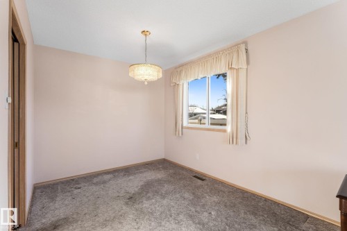 Unfurnished room with carpet flooring and a chandelier - 3519 111B Street, Edmonton, AB - Indoor Photo Showing Other Room