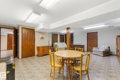 Dining room featuring a textured ceiling and light tile patterned floors - 3519 111B Street, Edmonton, AB - Indoor