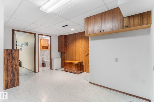 Spare room with light floors, a paneled ceiling, and wood walls - 3519 111B Street, Edmonton, AB - Indoor Photo Showing Other Room