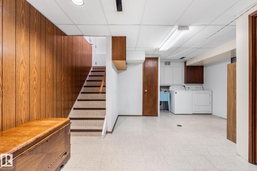 Finished basement with a paneled ceiling, light floors, and washing machine and clothes dryer - 3519 111B Street, Edmonton, AB - Indoor Photo Showing Laundry Room