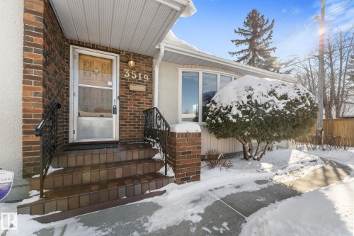 Snow covered property entrance with brick siding - 3519 111B Street, Edmonton, AB - Outdoor