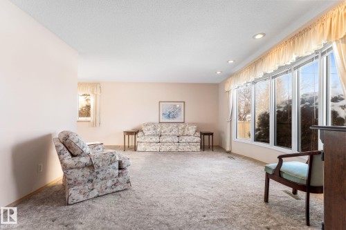Carpeted living area featuring a textured ceiling and recessed lighting - 3519 111B Street, Edmonton, AB - Indoor Photo Showing Living Room
