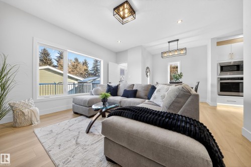 Living area with recessed lighting and light wood-type flooring - 9907 68 Street, Edmonton, AB - Indoor Photo Showing Living Room