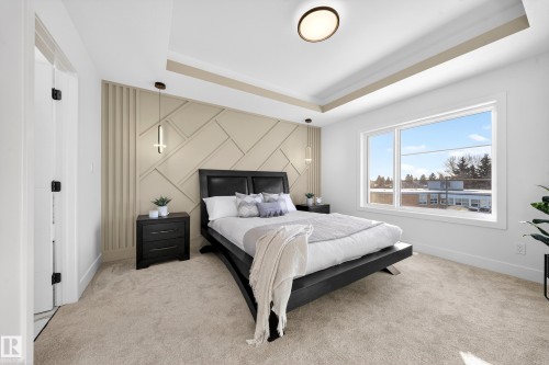 Bedroom featuring a tray ceiling, light colored carpet, and an accent wall - 9907 68 Street, Edmonton, AB - Indoor Photo Showing Bedroom