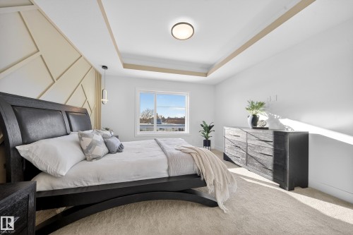 Carpeted bedroom with a tray ceiling and baseboards - 9907 68 Street, Edmonton, AB - Indoor Photo Showing Bedroom